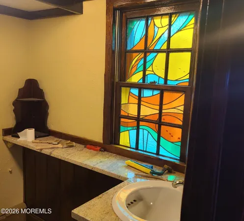 a bathroom with a sink and a window