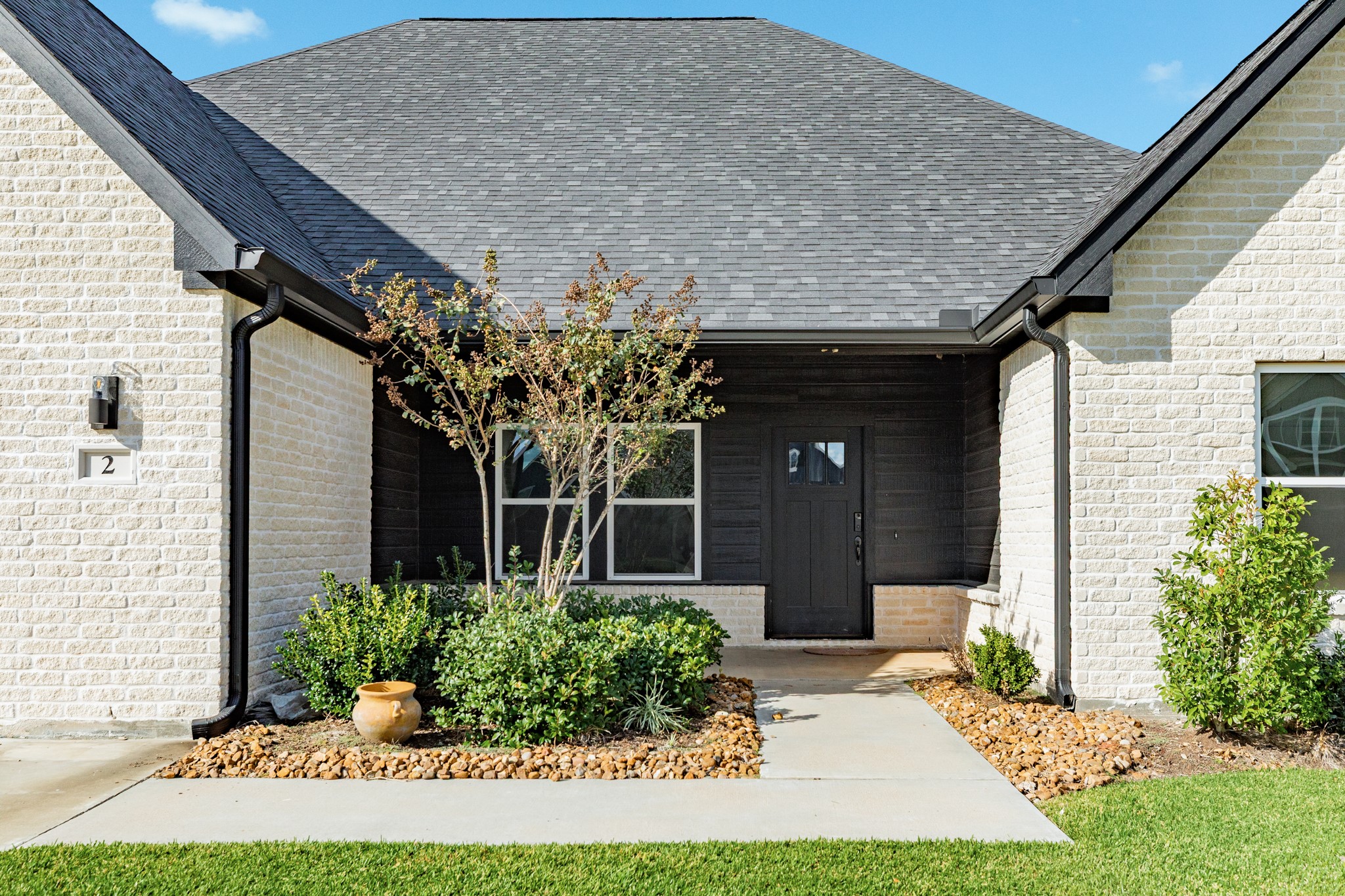 2 Greystone Court Angleton, TX 77515 - Photo 8 of 34 a front view of a house with garden