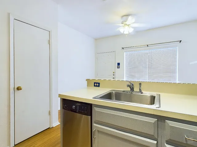a kitchen with a sink and a refrigerator