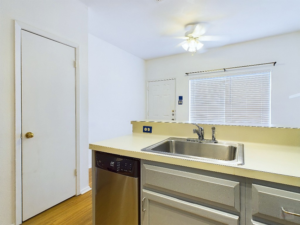 2210 Pearl Street, Unit 204 Austin, TX 78705 - Photo 2 of 10 a kitchen with a sink and a refrigerator