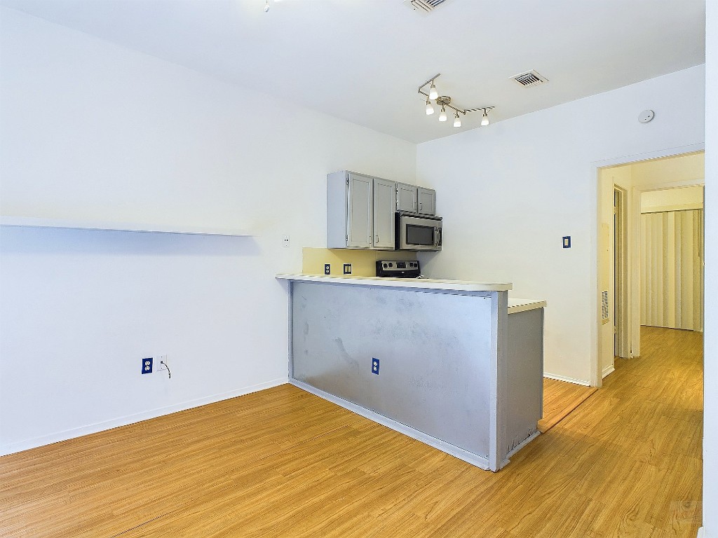2210 Pearl Street, Unit 204 Austin, TX 78705 - Photo 3 of 10 a kitchen with a refrigerator and a sink