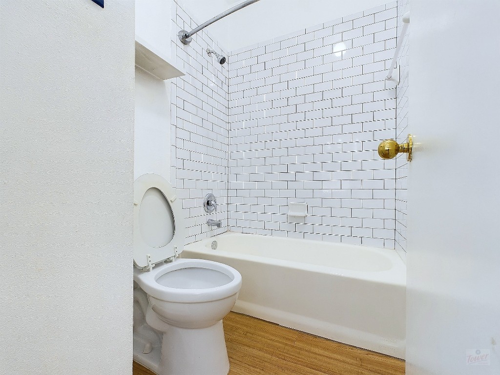 2210 Pearl Street, Unit 204 Austin, TX 78705 - Photo 5 of 10 a bathroom with a sink a toilet and shower