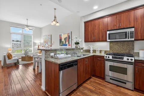 a kitchen with a stove sink and microwave