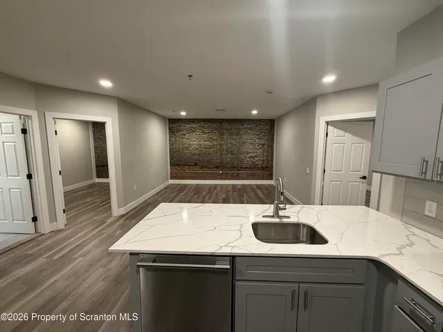 a kitchen with a sink and a refrigerator