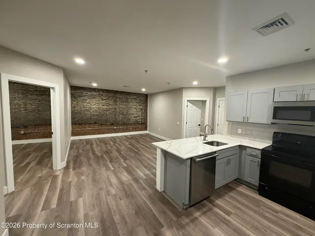 a kitchen with a sink stove and cabinets