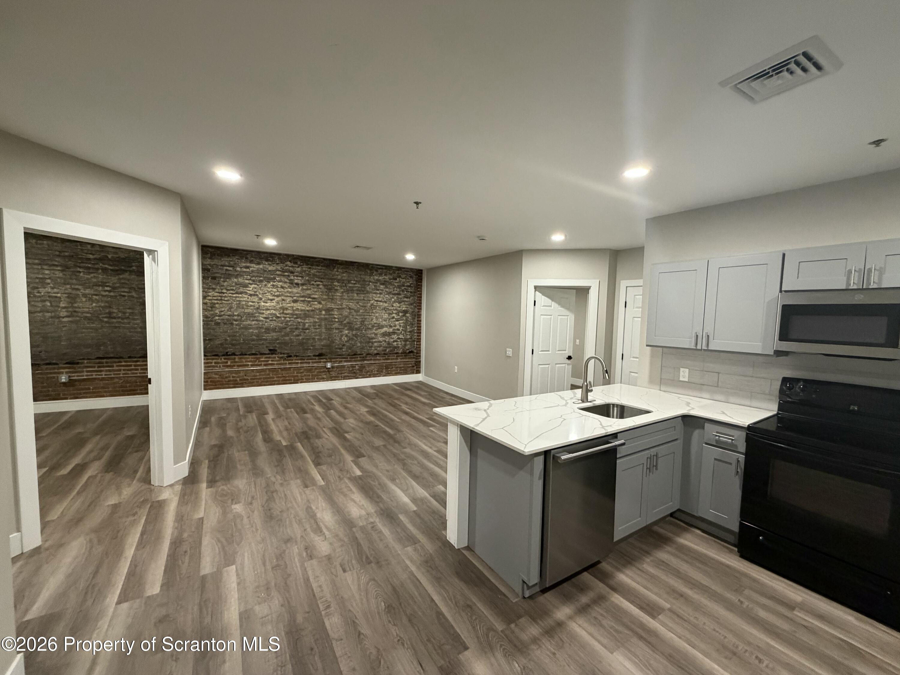 205 North Washington Avenue, Unit 7 Scranton, PA 18503 - Photo 2 of 7 a kitchen with a sink stove and cabinets