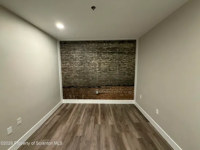 a view of room with wooden floor