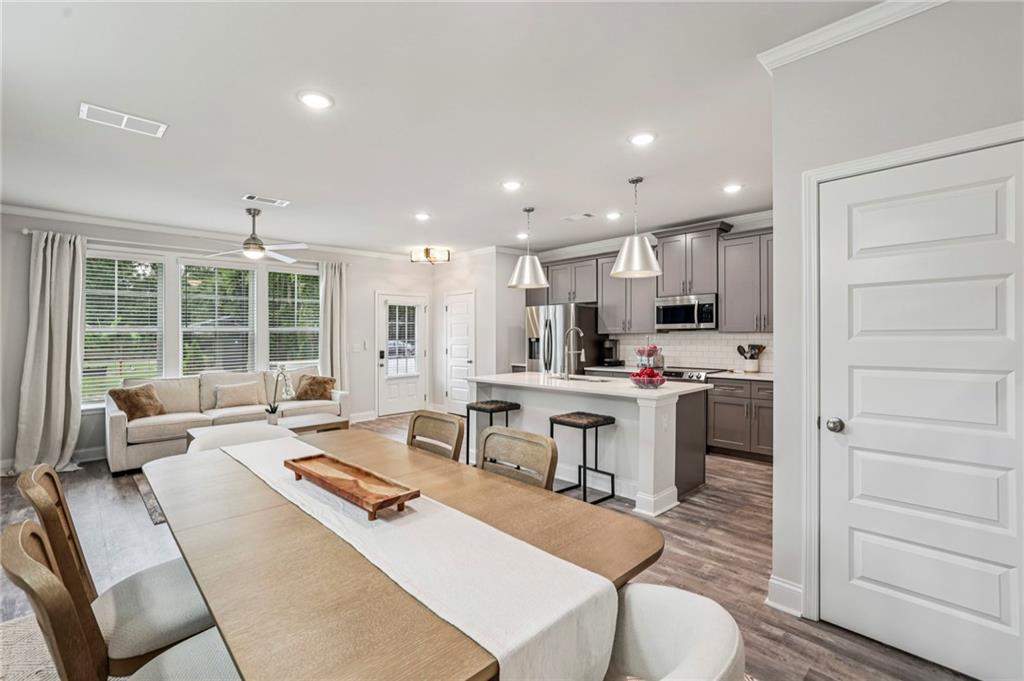 5064 Insperon Lane, Unit 34 Peachtree Corners, GA 30092 - Photo 11 of 48 a living room with stainless steel appliances kitchen island granite countertop a sink and cabinets