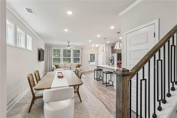 a view of a dining room with furniture window and wooden floor
