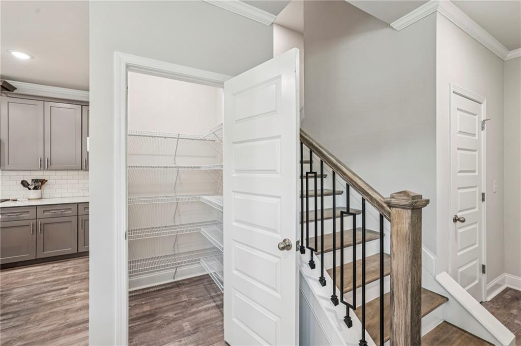 5064 Insperon Lane, Unit 34 Peachtree Corners, GA 30092 - Photo 13 of 48 a view of a hallway with wooden floor and staircase