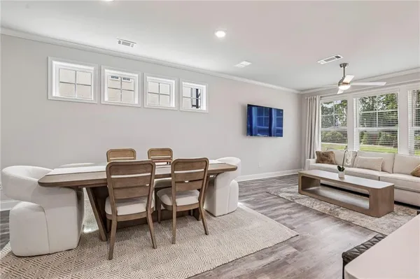 a dining room with furniture and window