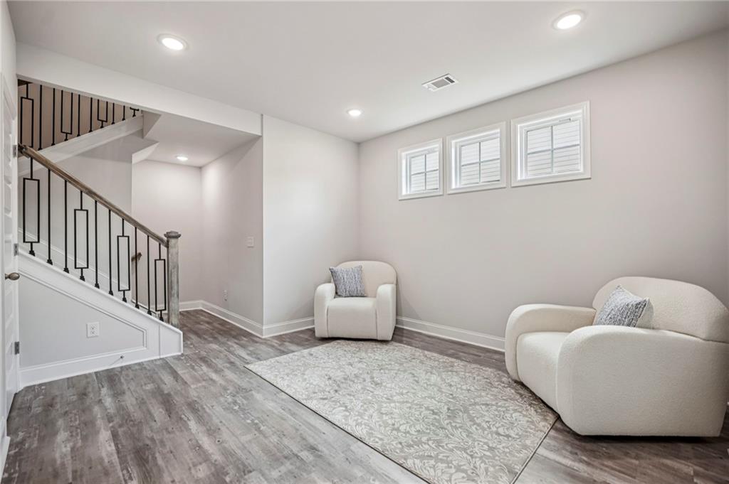 5064 Insperon Lane, Unit 34 Peachtree Corners, GA 30092 - Photo 17 of 48 a living room with furniture and a wooden floor