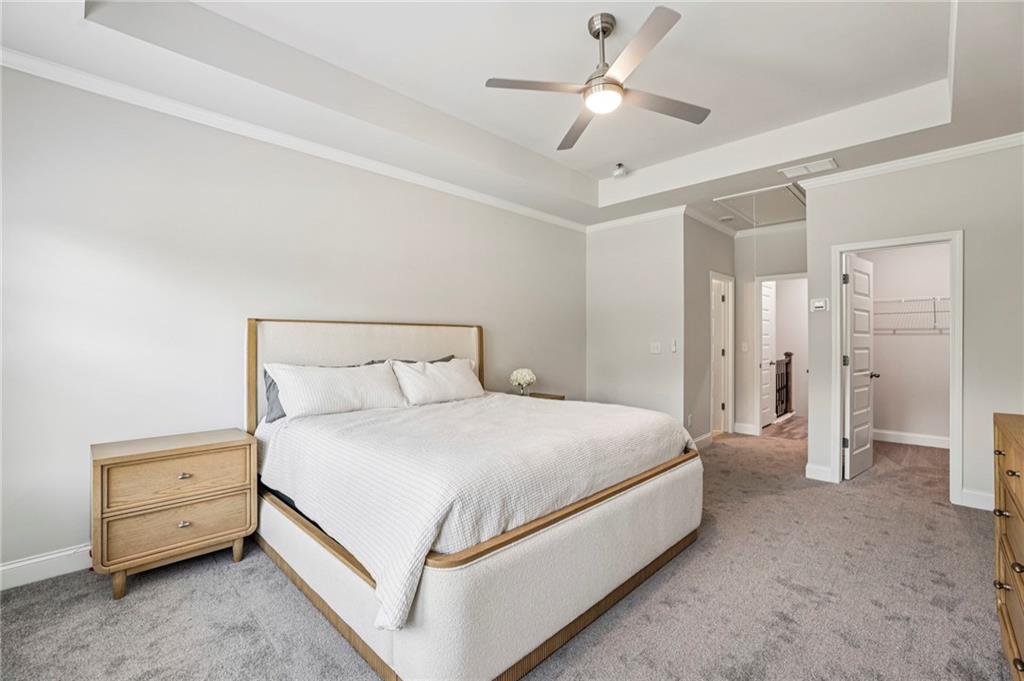 5064 Insperon Lane, Unit 34 Peachtree Corners, GA 30092 - Photo 20 of 48 a bedroom with a bed and a chandelier