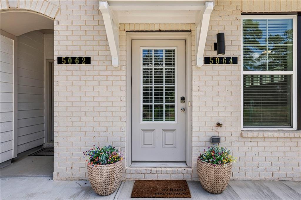 5064 Insperon Lane, Unit 34 Peachtree Corners, GA 30092 - Photo 2 of 48 a potted plant sitting on the side of a house