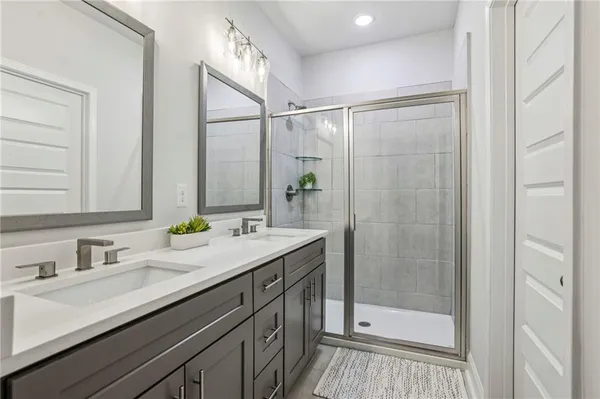 a bathroom with a shower sink and mirror
