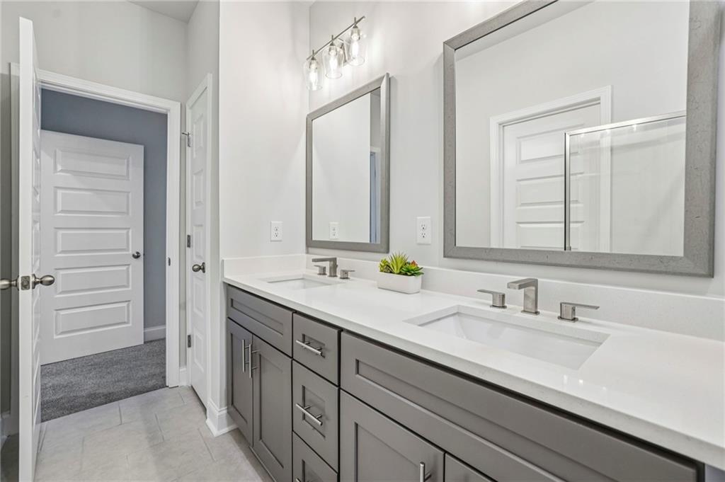 5064 Insperon Lane, Unit 34 Peachtree Corners, GA 30092 - Photo 22 of 48 a bathroom with a double vanity sink and a mirror