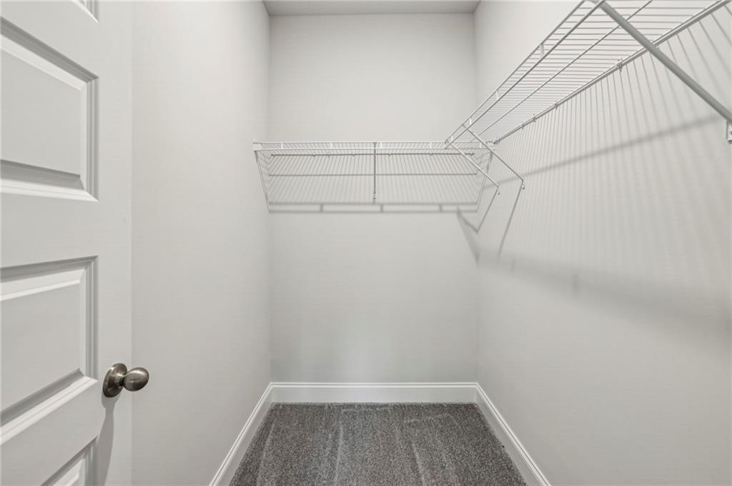 5064 Insperon Lane, Unit 34 Peachtree Corners, GA 30092 - Photo 23 of 48 a view of a room with racks on the wall