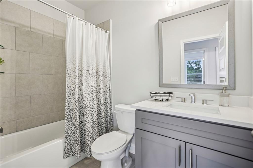 5064 Insperon Lane, Unit 34 Peachtree Corners, GA 30092 - Photo 25 of 48 a bathroom with a sink a toilet and shower