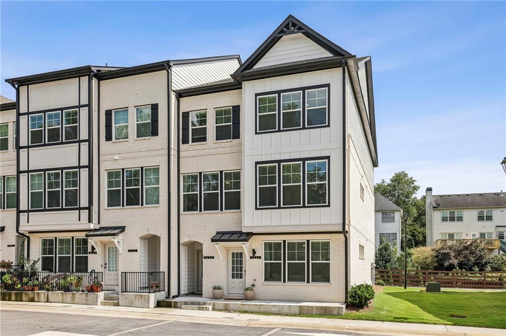 5064 Insperon Lane, Unit 34 Peachtree Corners, GA 30092 - Photo 28 of 48 a front view of a building with a yard