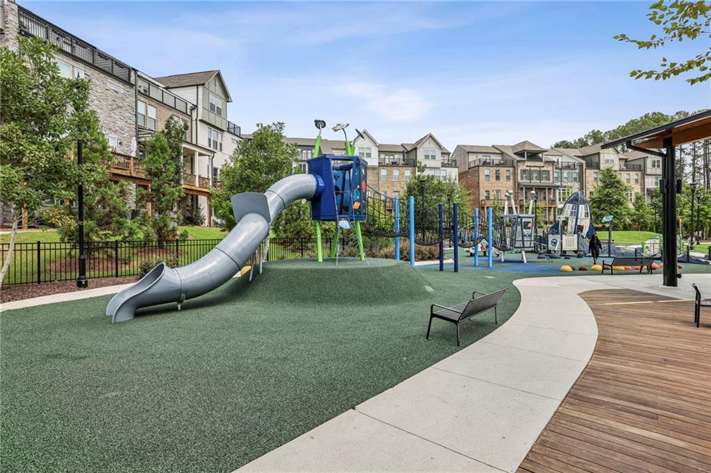 5064 Insperon Lane, Unit 34 Peachtree Corners, GA 30092 - Photo 39 of 48 a view of a park with swings and slides