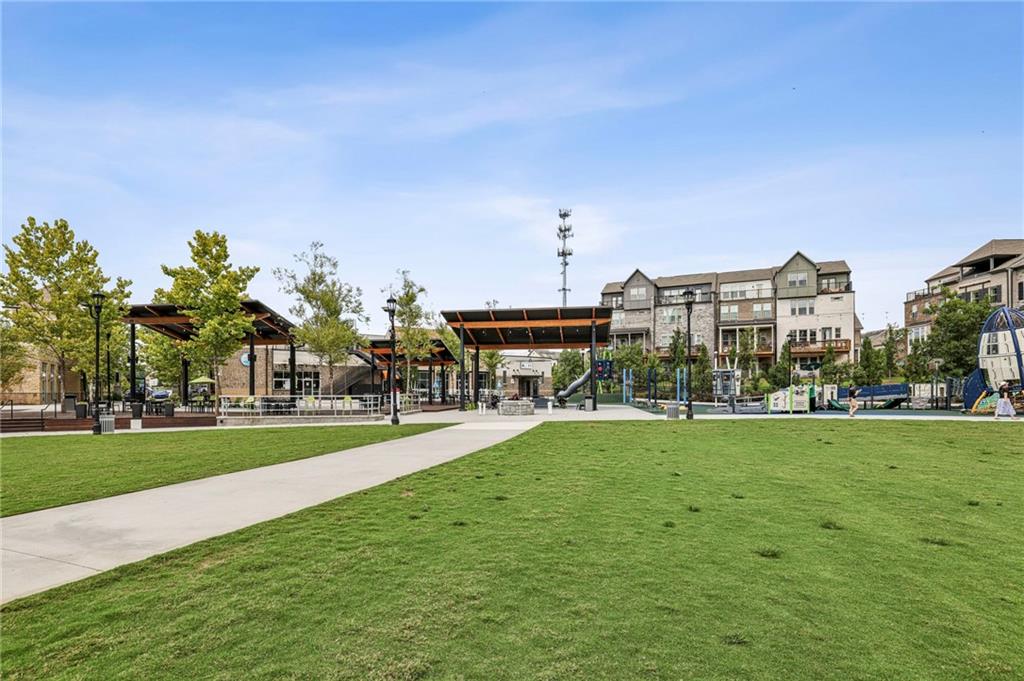 5064 Insperon Lane, Unit 34 Peachtree Corners, GA 30092 - Photo 40 of 48 a view of a big yard with a house in the background