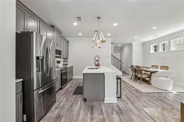 a kitchen with a sink appliances and cabinets