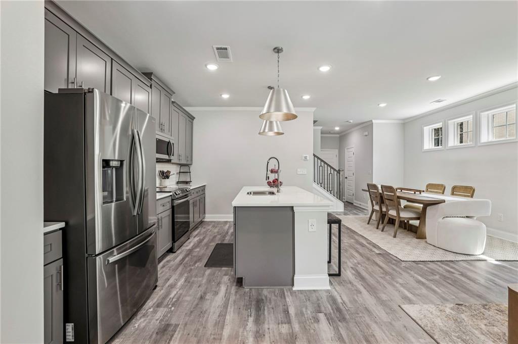 5064 Insperon Lane, Unit 34 Peachtree Corners, GA 30092 - Photo 4 of 48 a kitchen with a sink appliances and cabinets