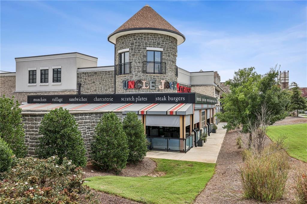 5064 Insperon Lane, Unit 34 Peachtree Corners, GA 30092 - Photo 43 of 48 a front view of a house with a yard