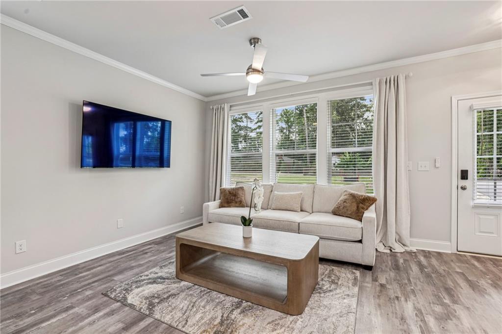 5064 Insperon Lane, Unit 34 Peachtree Corners, GA 30092 - Photo 8 of 48 a living room with furniture and a large window