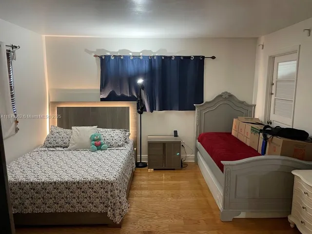 a bedroom with a bed and a dresser