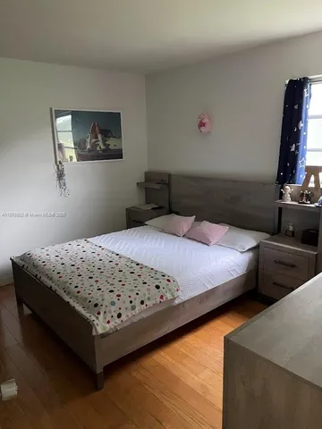 a bedroom with bed and cabinets