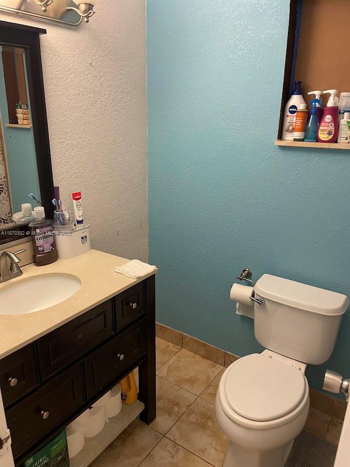 2500 Southwest 81st Avenue, Unit 102 Davie, FL 33324 - Photo 9 of 9 a bathroom with a toilet a sink and mirror