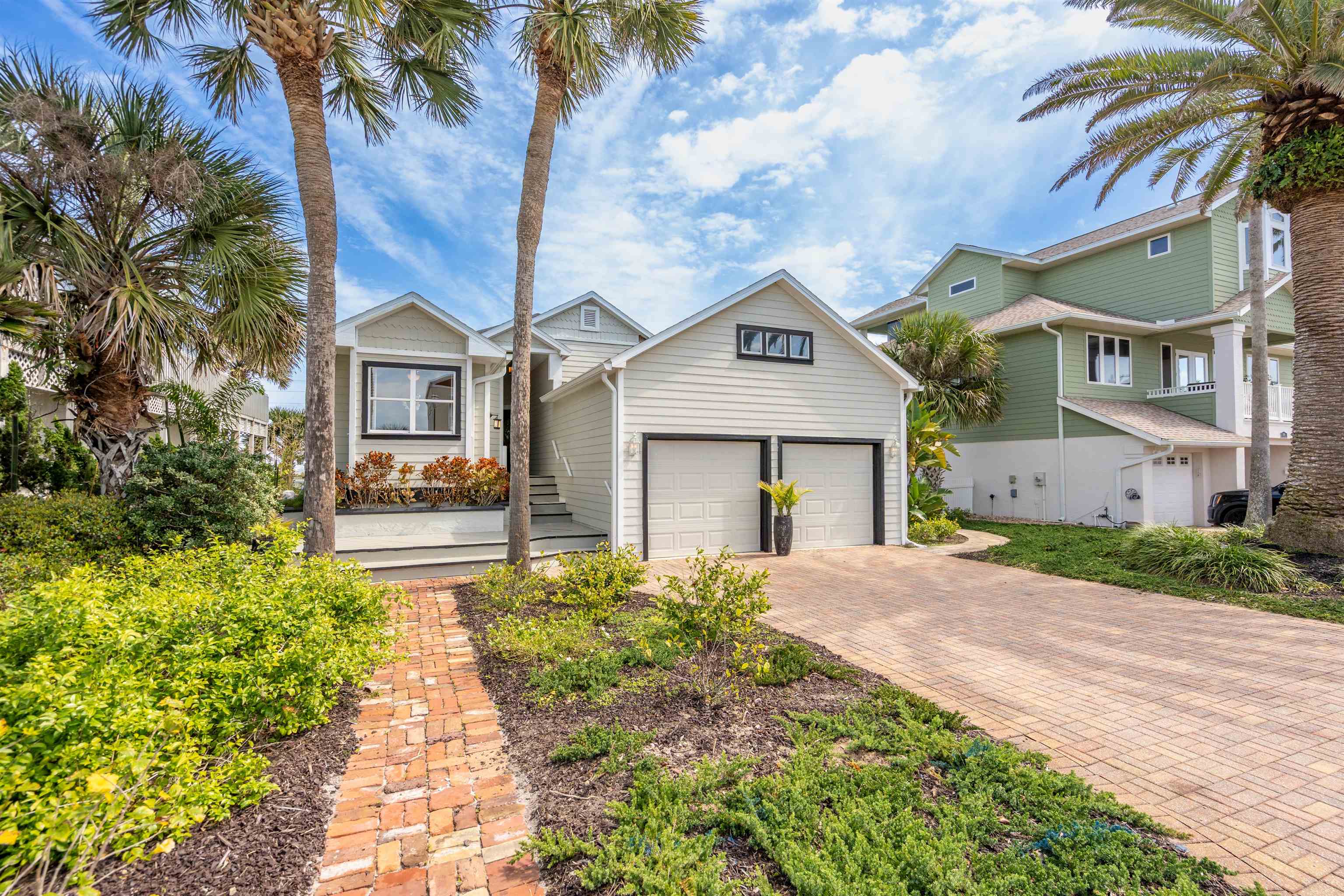 9244 July Lane St. Augustine, FL 32080 - Photo 2 of 66 a front view of a house with a yard