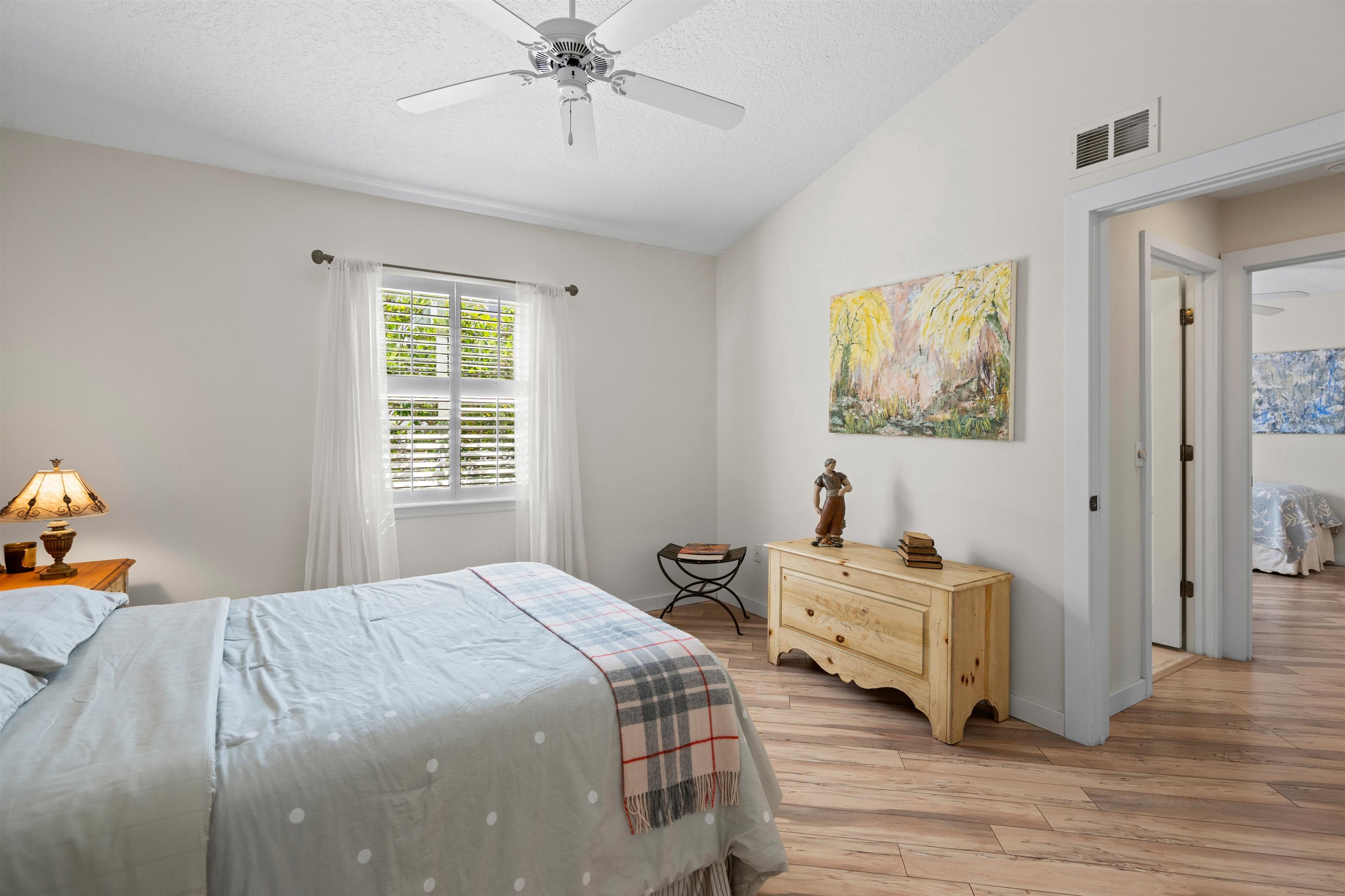 9244 July Lane St. Augustine, FL 32080 - Photo 23 of 66 a bedroom with a bed and wooden floor