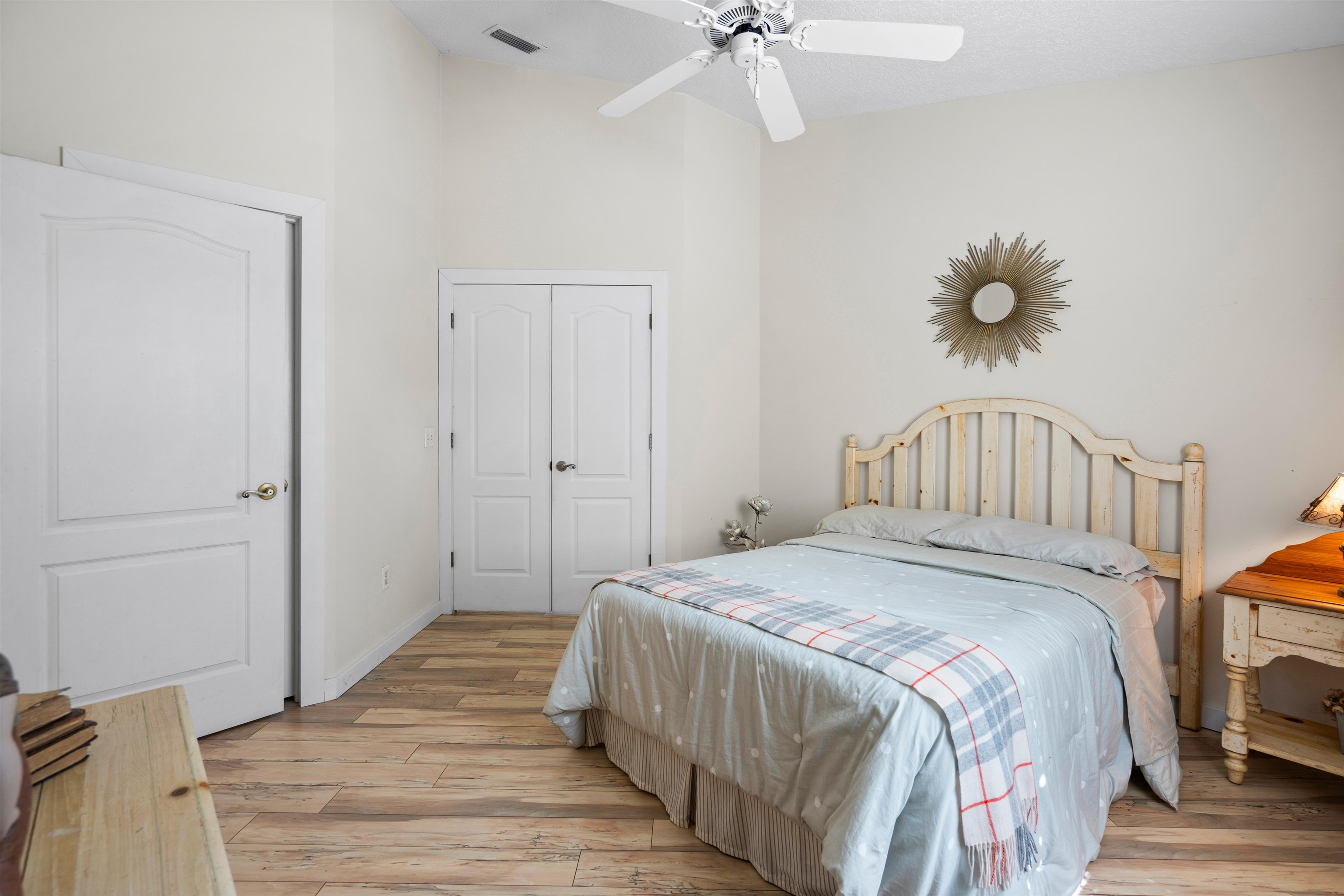 9244 July Lane St. Augustine, FL 32080 - Photo 25 of 66 a bedroom with a bed and a chandelier