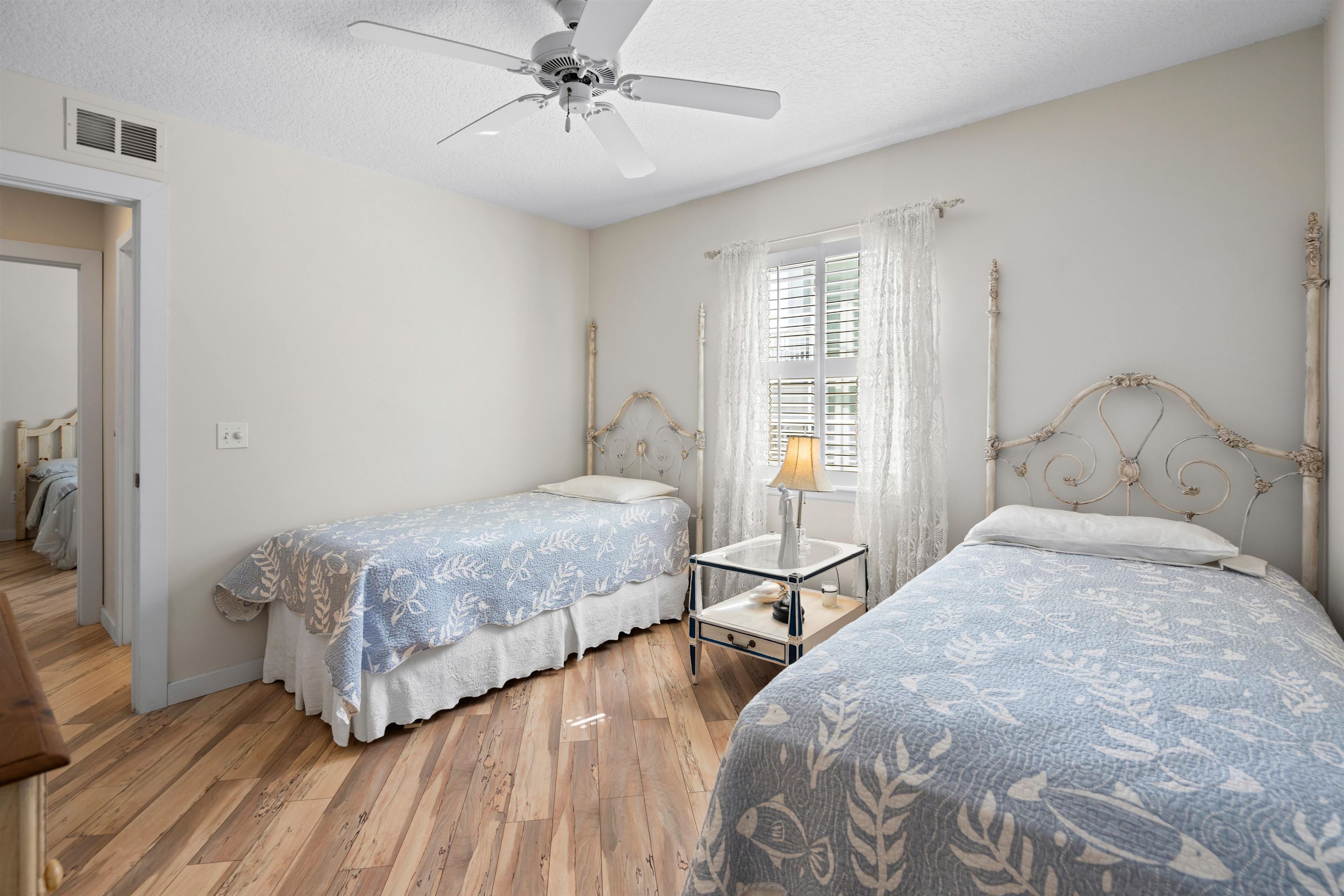 9244 July Lane St. Augustine, FL 32080 - Photo 28 of 66 a bedroom with a bed and wooden floor