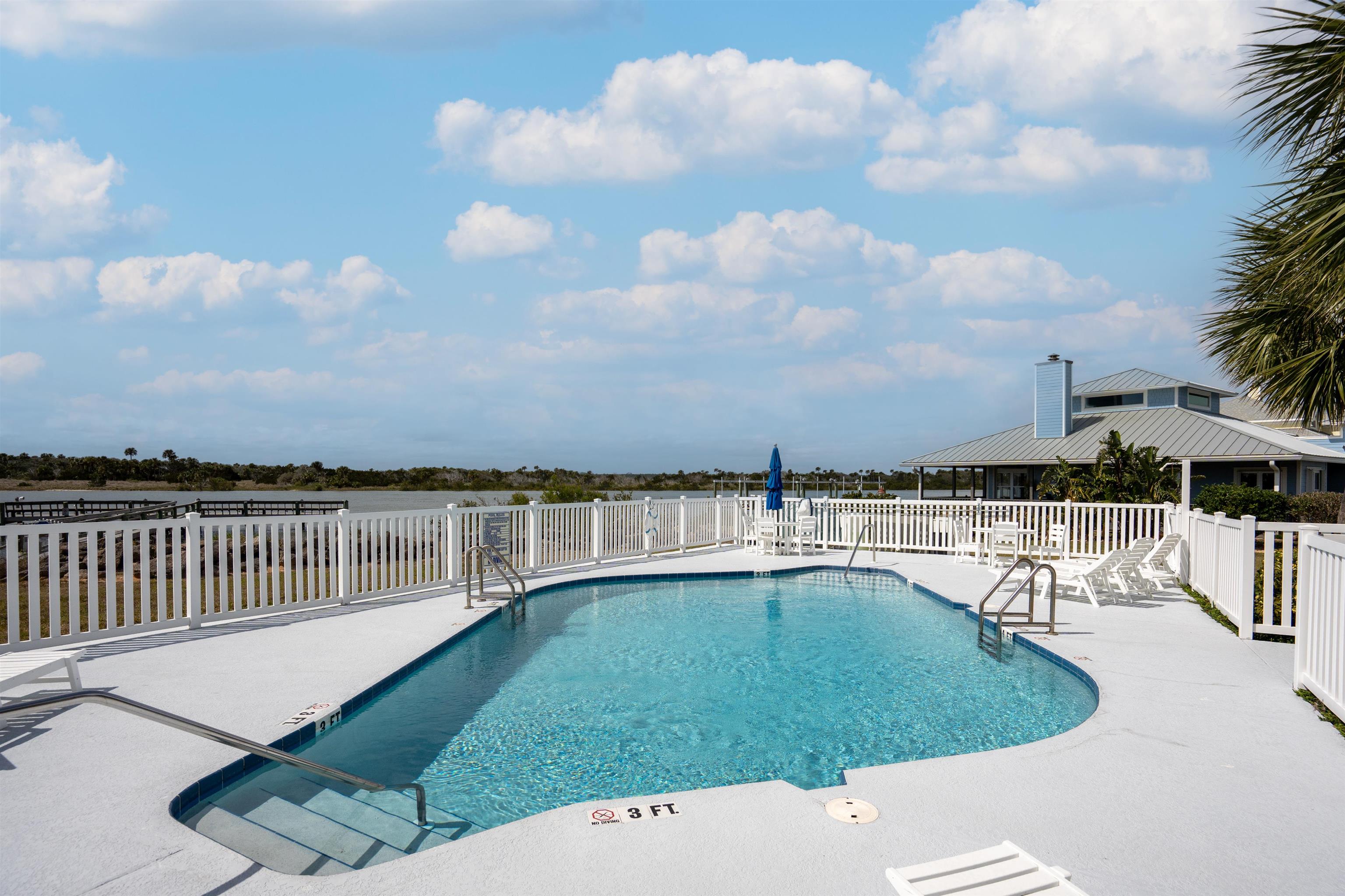 9244 July Lane St. Augustine, FL 32080 - Photo 57 of 66 a view of a swimming pool with a lounge chairs