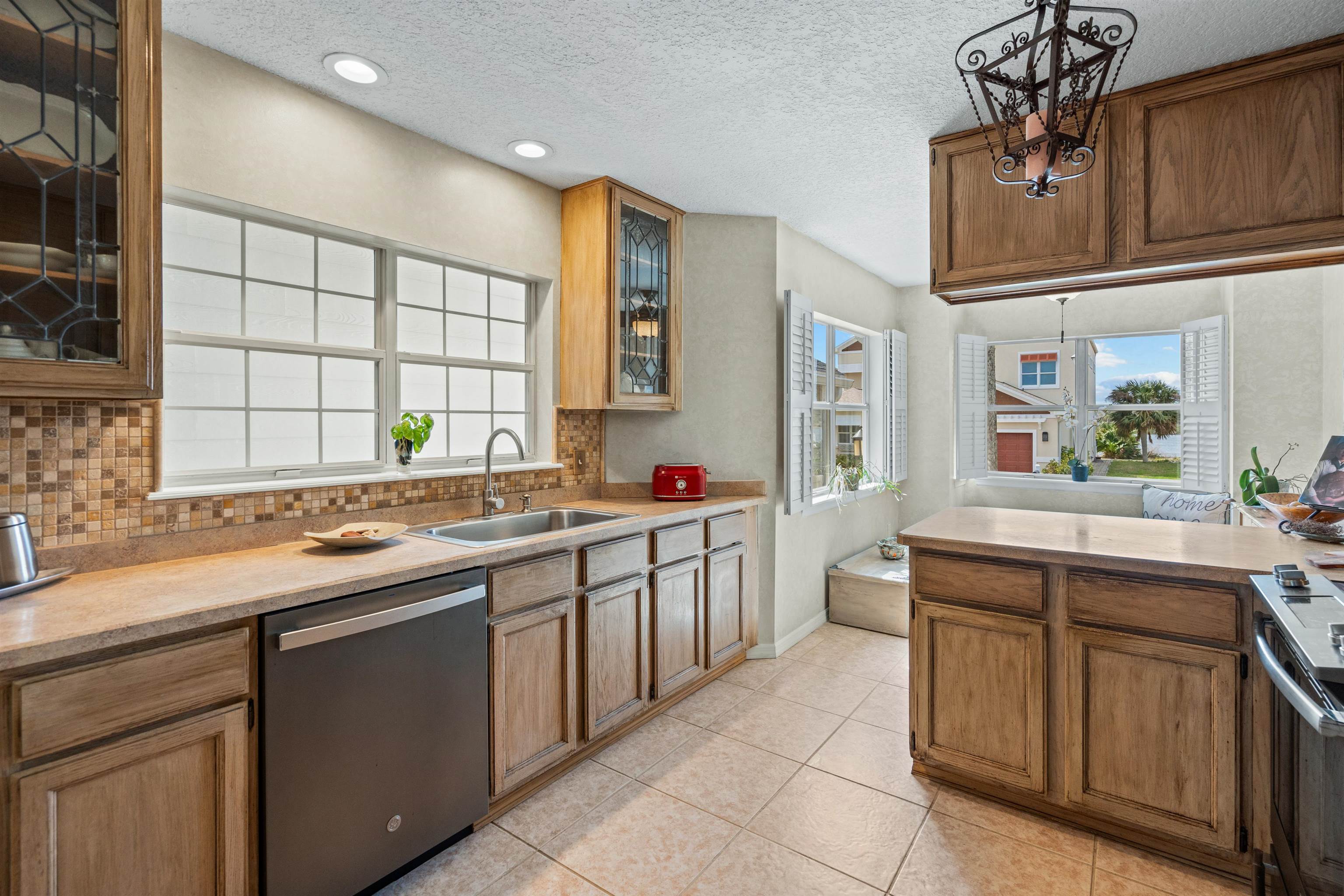 9244 July Lane St. Augustine, FL 32080 - Photo 7 of 66 a kitchen with stainless steel appliances a sink and cabinets