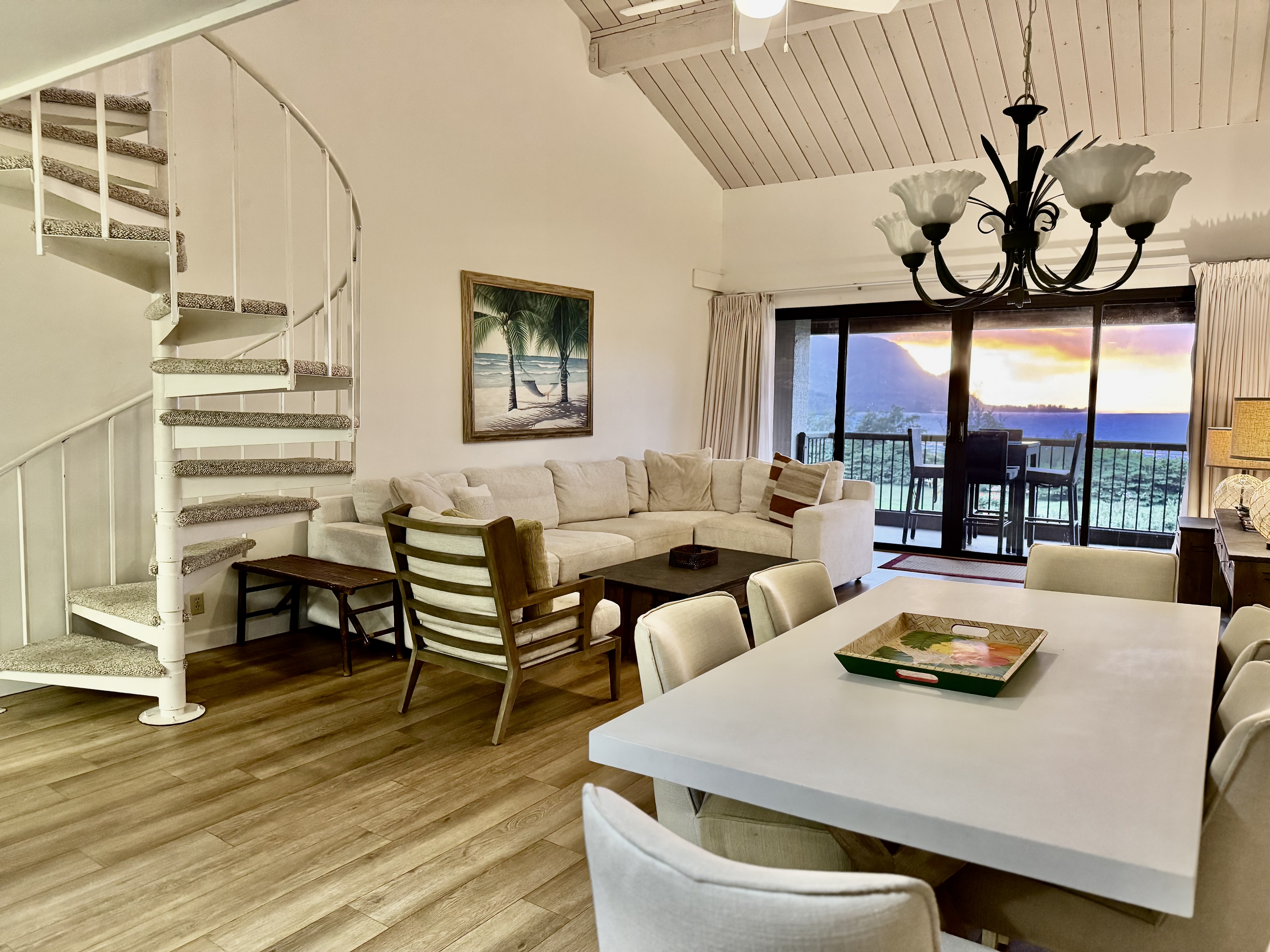 a view of a dining room with furniture wooden floor and chandelier