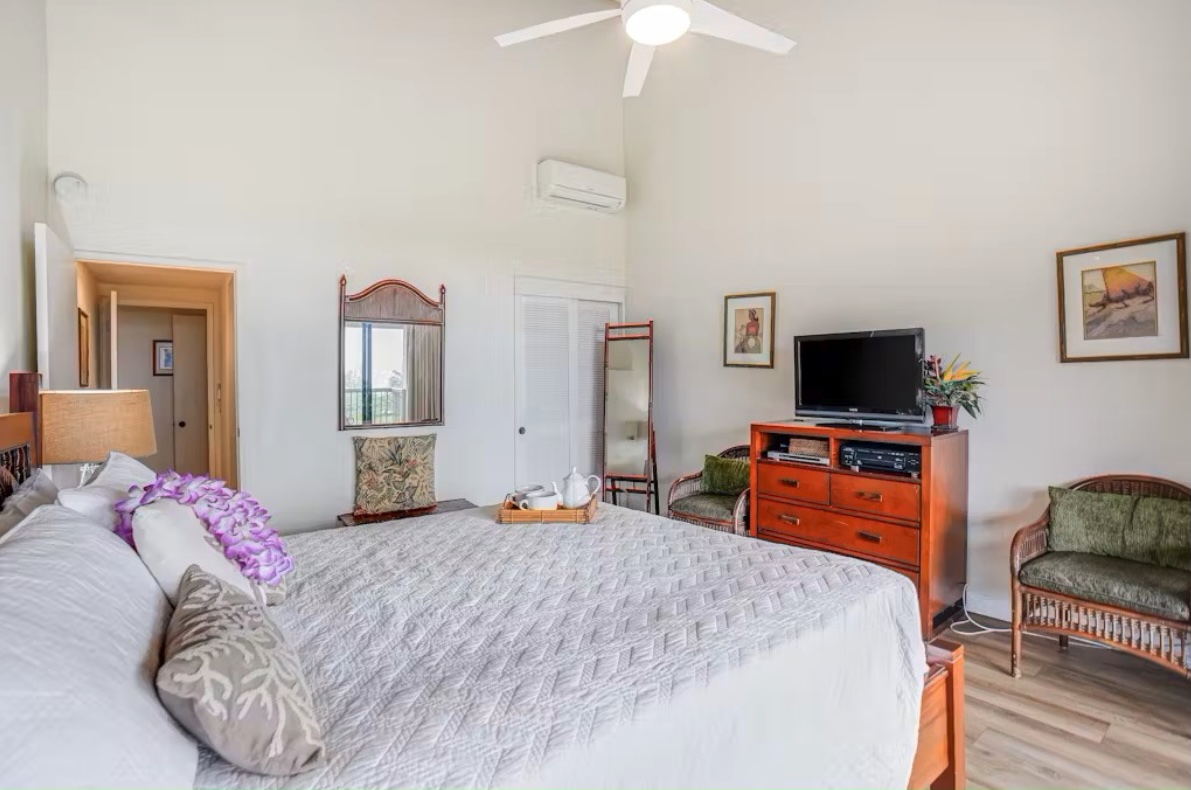 5380 Honoiki Road, Unit J33 Princeville, HI 96722 - Photo 18 of 30 a bedroom with furniture and flat screen tv
