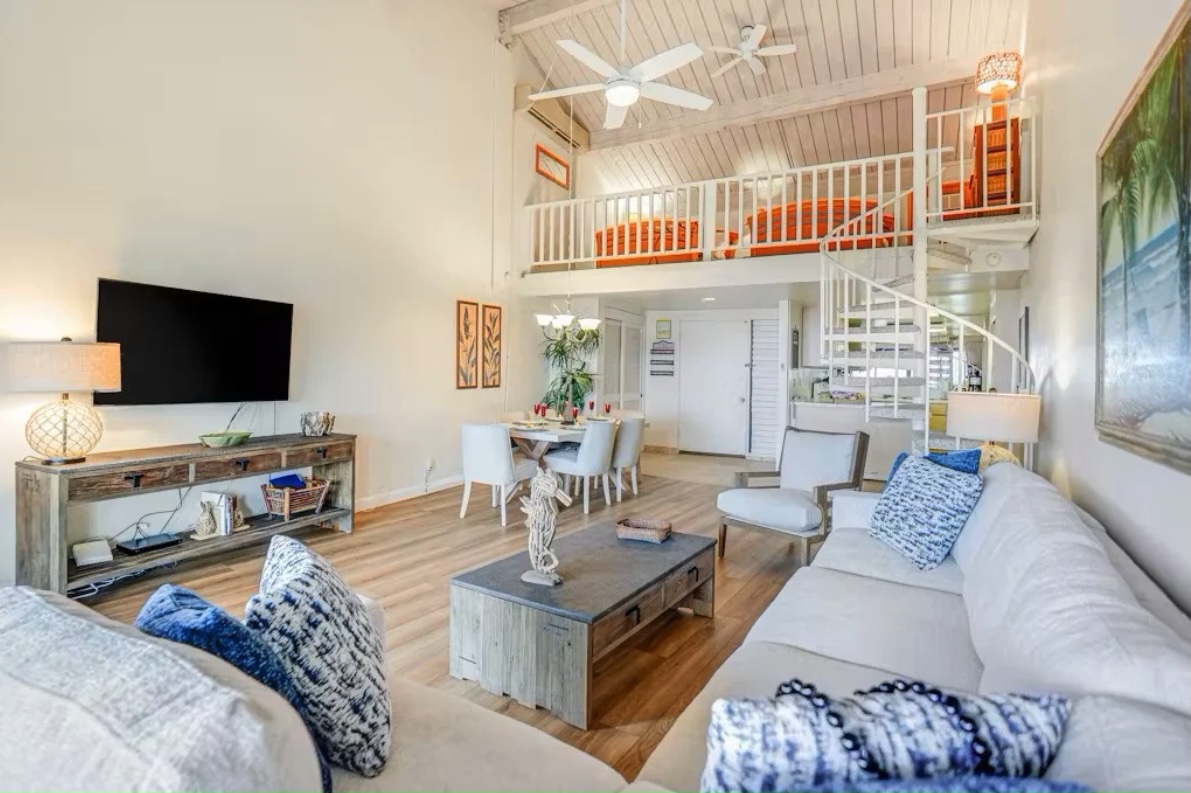 5380 Honoiki Road, Unit J33 Princeville, HI 96722 - Photo 5 of 30 a living room with furniture and a flat screen tv