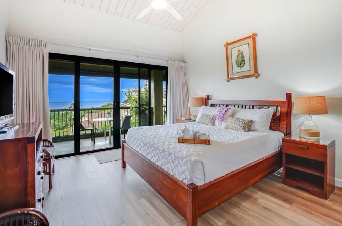 5380 Honoiki Road, Unit J33 Princeville, HI 96722 - Photo 8 of 30 a bed sitting in a spacious bedroom next to a window