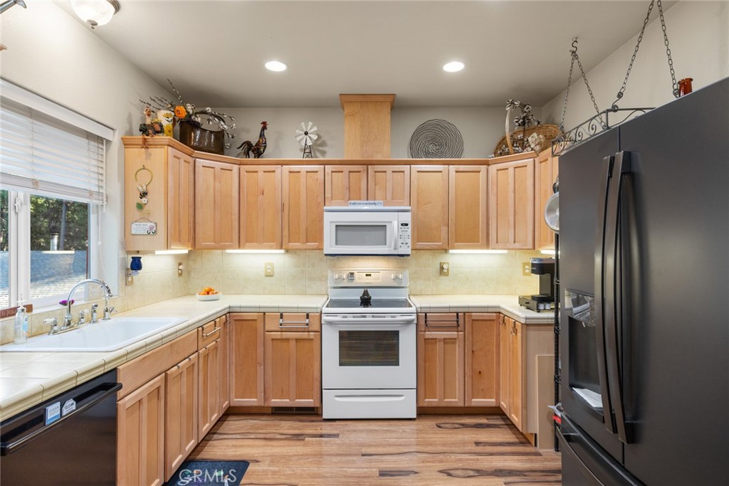 6341 Amherst Way Magalia, CA 95954 - Photo 9 of 28 a kitchen with a sink stainless steel appliances and cabinets