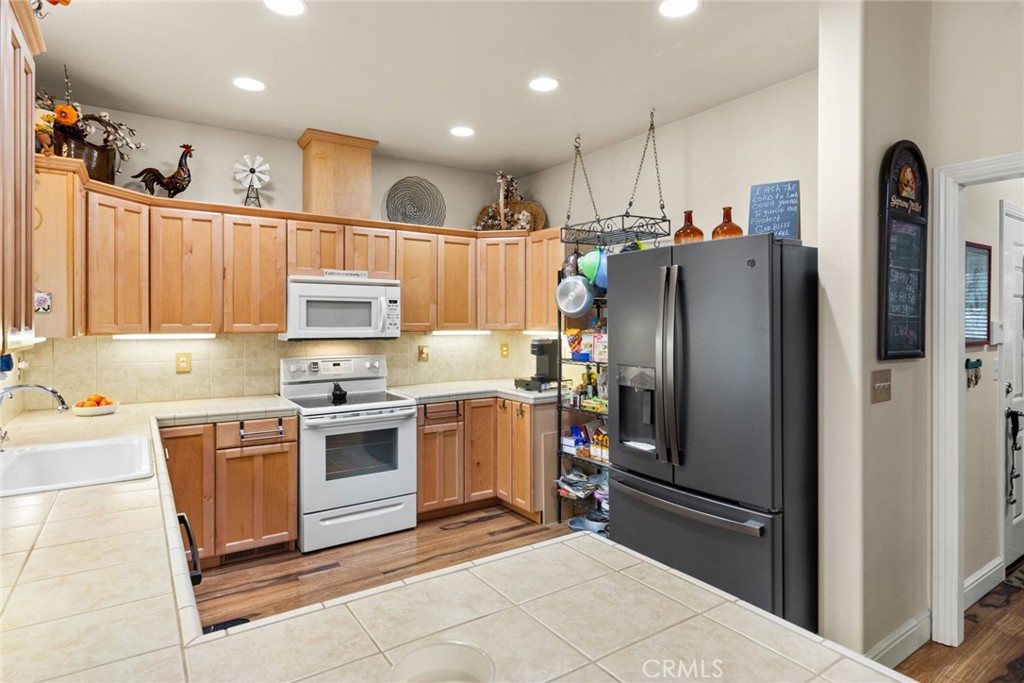 6341 Amherst Way Magalia, CA 95954 - Photo 10 of 28 a kitchen with stainless steel appliances granite countertop a refrigerator oven a sink and dishwasher