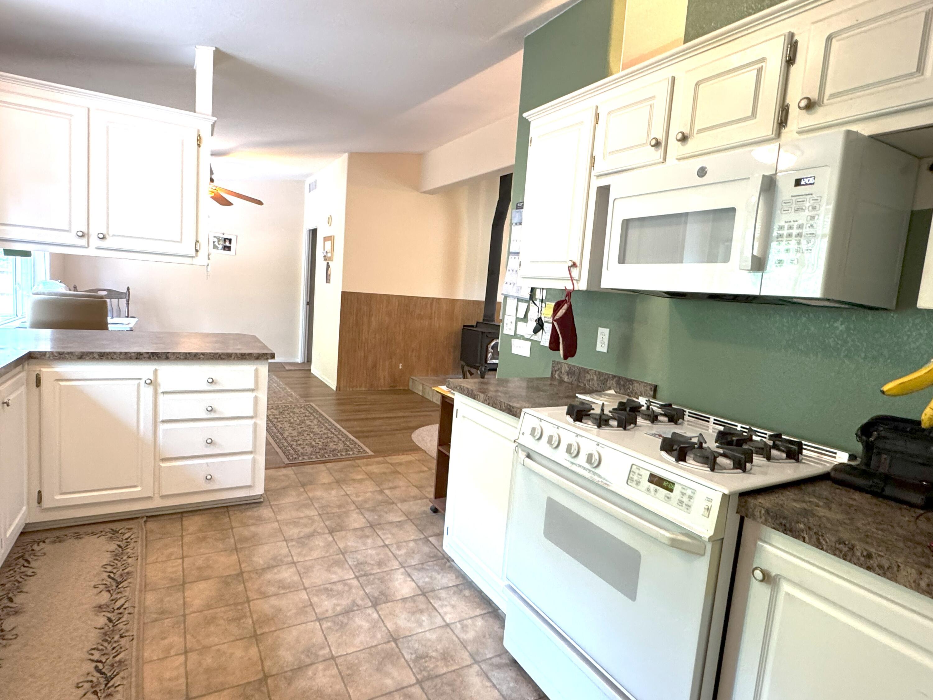 29093 Day Road McArthur, CA 96056 - Photo 14 of 39 a kitchen with a stove cabinets and a refrigerator