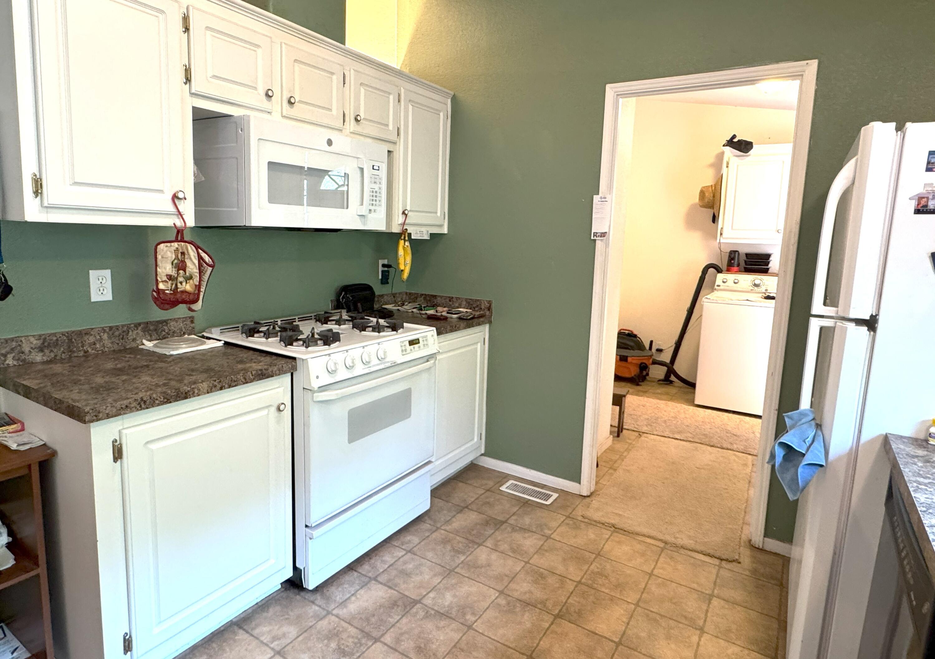 29093 Day Road McArthur, CA 96056 - Photo 15 of 39 a view of a kitchen with fridge and wooden floor