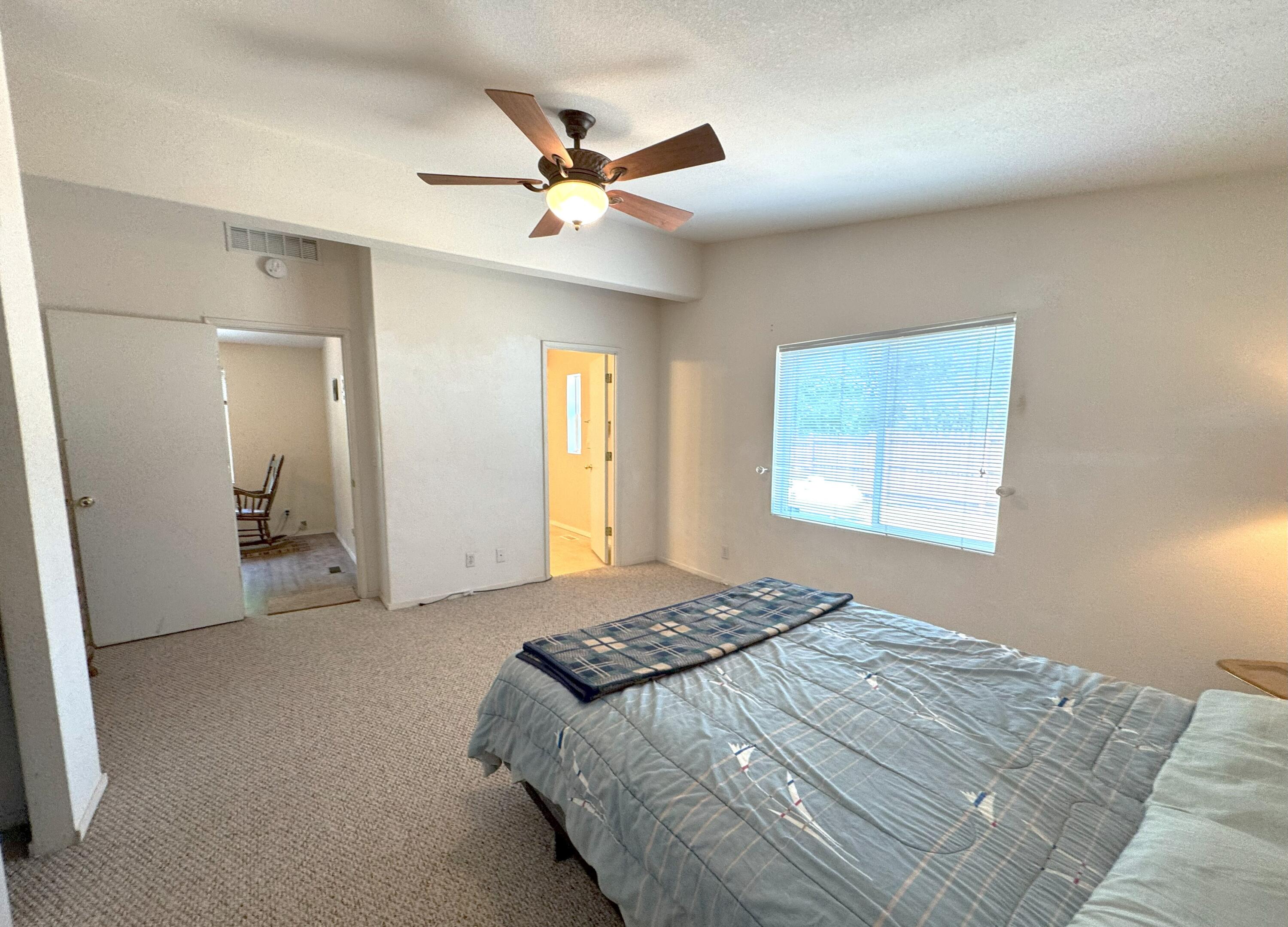 29093 Day Road McArthur, CA 96056 - Photo 19 of 39 a bedroom with a large bed and a chandelier
