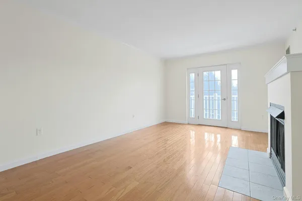 wooden floor in an empty room with a fireplace