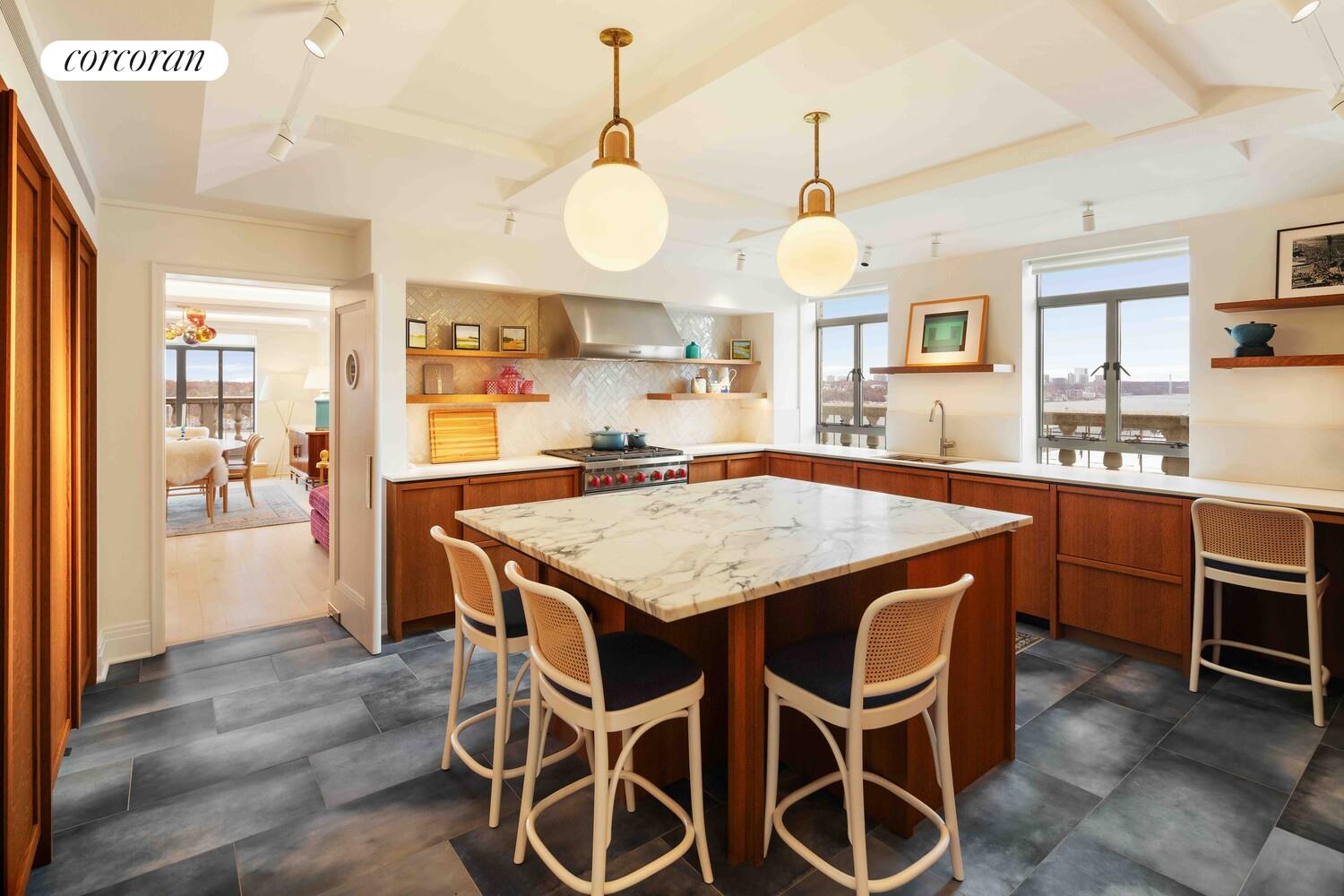 140 Riverside Drive, Unit 19HO Manhattan, NY 10024 - Photo 22 of 35 a open kitchen with granite countertop a sink and a chandelier