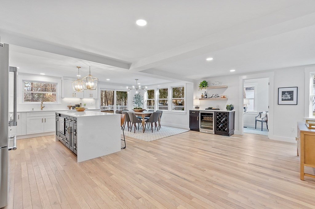 87 Parker Road Wellesley, MA 02482 - Photo 3 of 26 a large white kitchen with lots of counter space and a view of living room